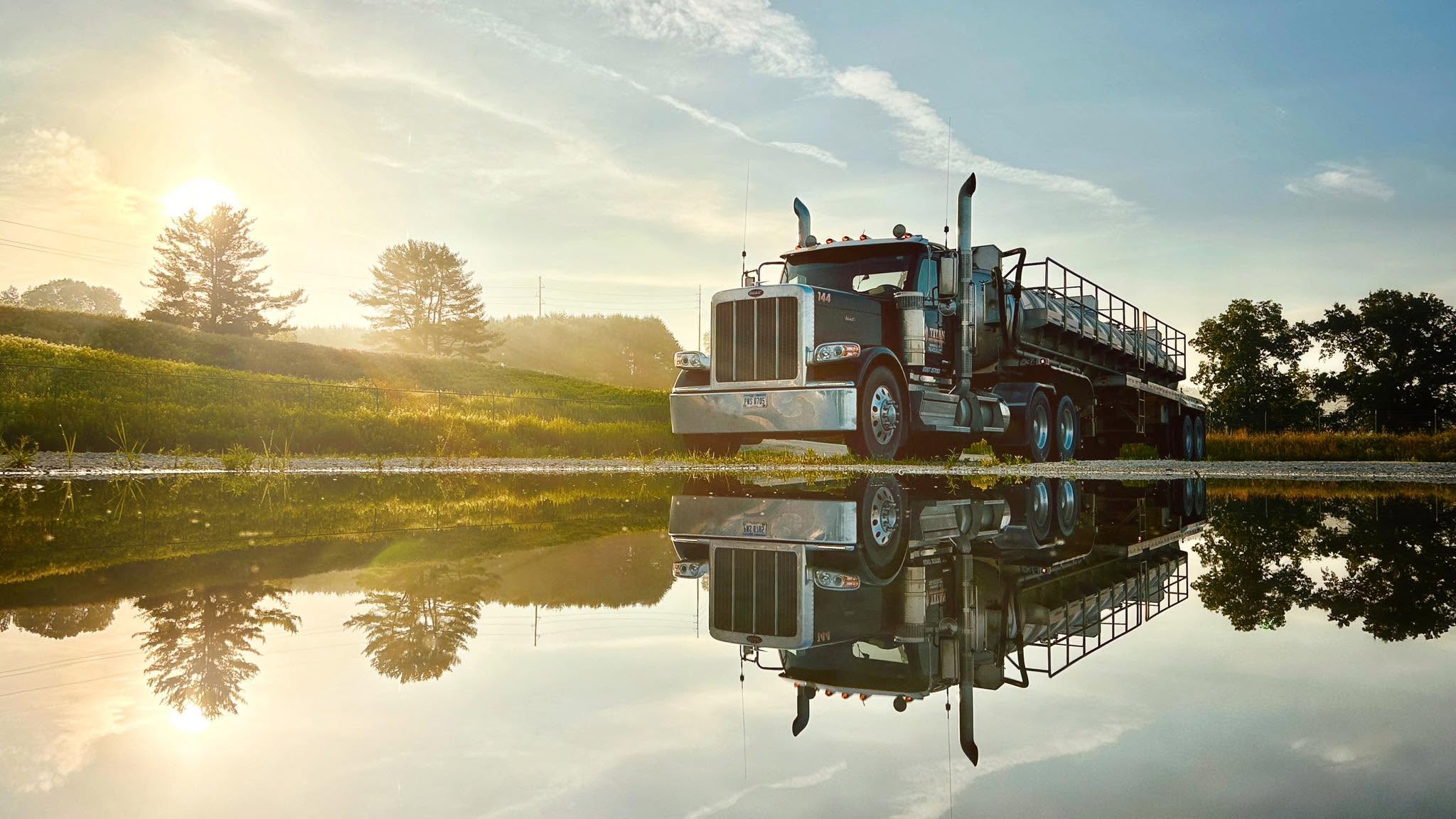 Titan Peterbilt at sunrise reflected in still water